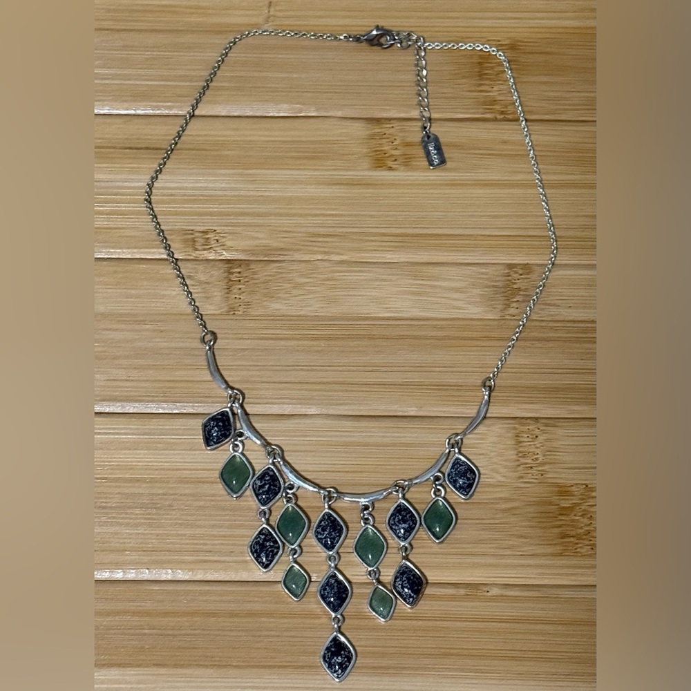 Liz & Co. silver-tone necklace featuring olive green and black speckled charms